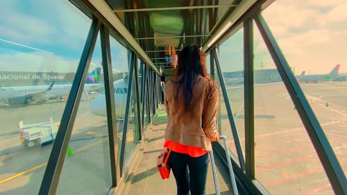 Woman Walking In A Jet Bridge