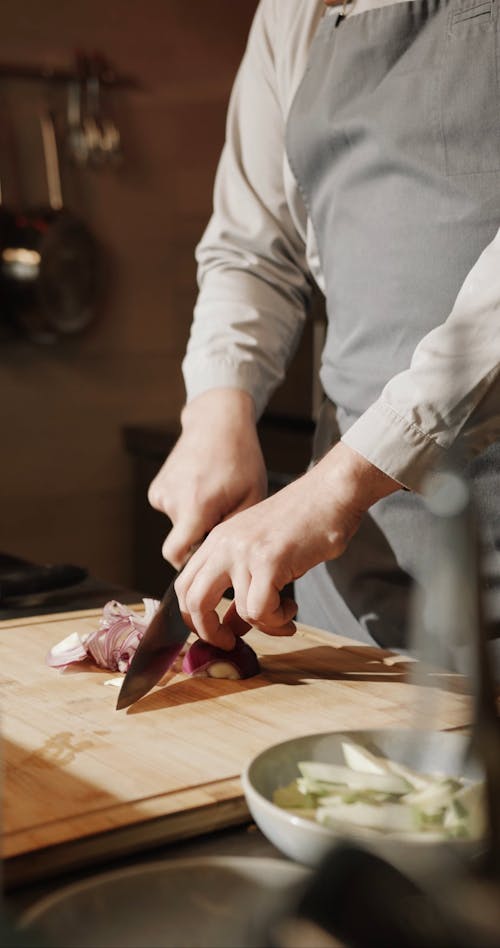 A Chef Cutting An Onion