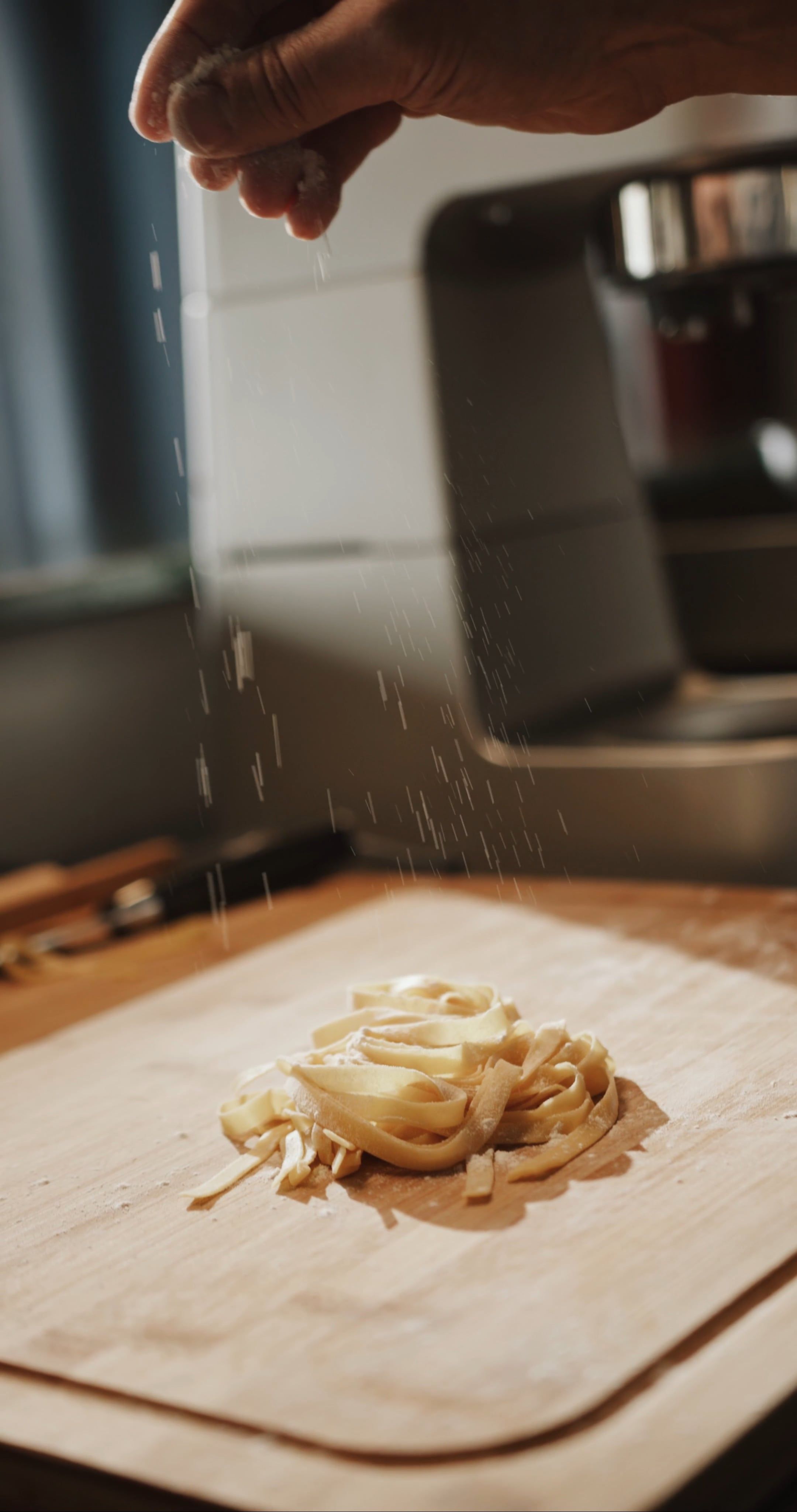 a person is cutting pasta on a cutting board 4252798