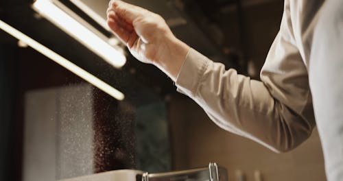 A Chef Sprinkling Flour on Freshly Made Pasta