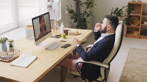 Video Of A Man Sitting In Front Of A Desk