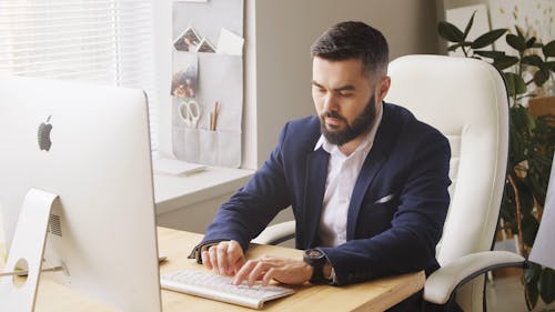 Man Typing On A Keyboard