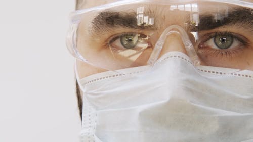 Man Wearing Face Mask And Protective Goggles