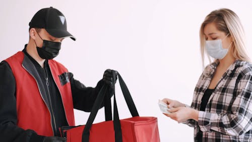 Woman With Face Mask Receiving a Box