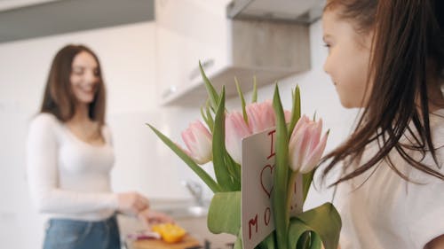 A Mom Receiving Flowers From His Young Daughter