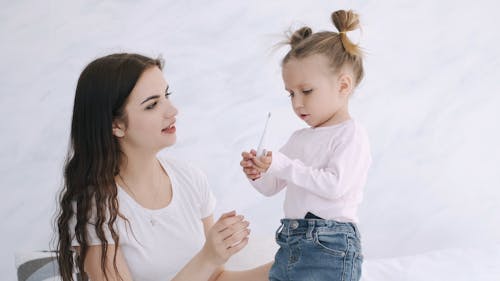 Mother Checking Little Girl's Temperature