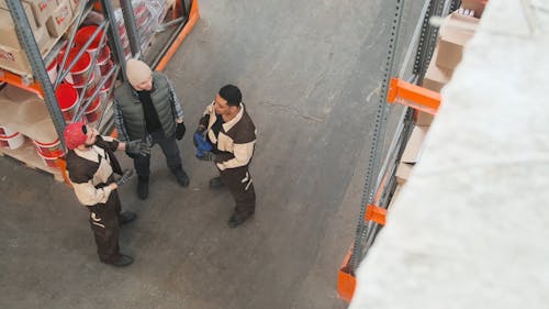 Three Men Working In A Hardware Store Warehouse