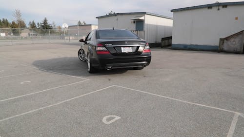 A Black Car Parked In A Parking Lot