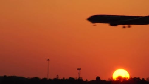 Silhouette Of An Airplane With Background View Of Sunset