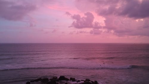 Drone Shot of a Beautiful Pink Sky in the Ocean
