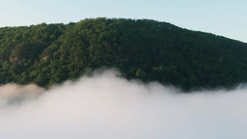 Drone Footage of  Clouds and a Mountain