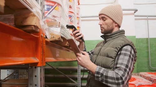 Man Checking Inventory In A Warehouse