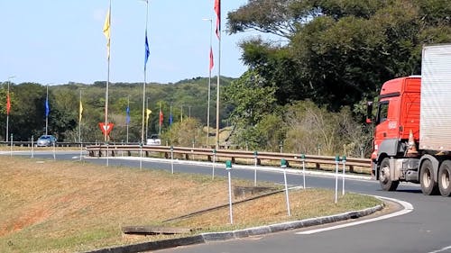 A Cargo Truck Entering The Highway Via The Shoulder Road