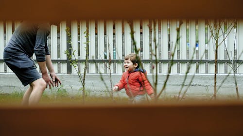 A Father Playing With His Boy In The Yard