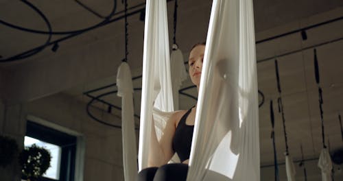 A Woman Practicing Aerial Dancing Inside A Studio