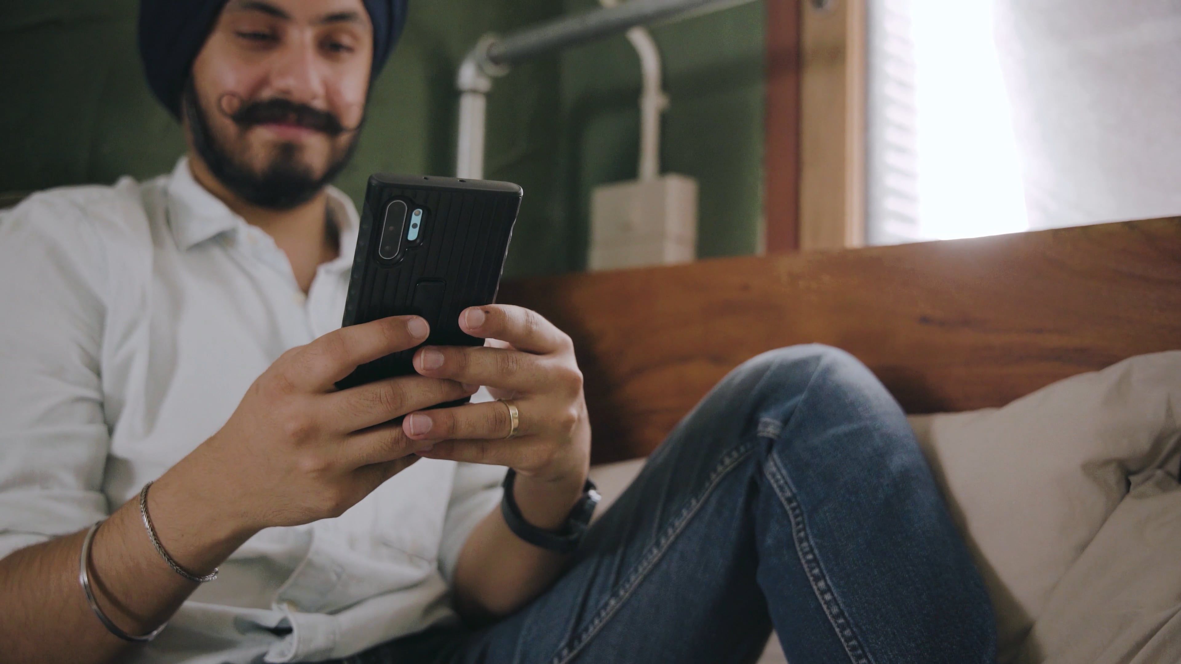A Man Smiling while Texting on his Phone Free Stock Video Footage ...