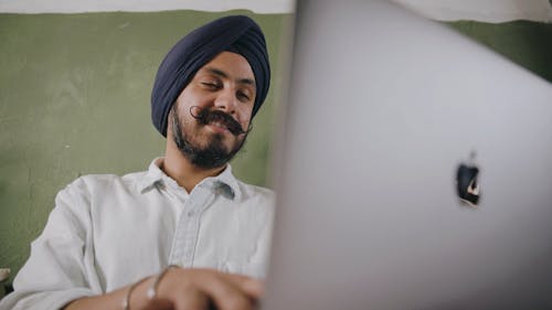 A Man Working On A Laptop