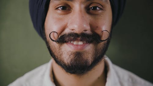 A Bearded Man With Moustache Wearing A Turban