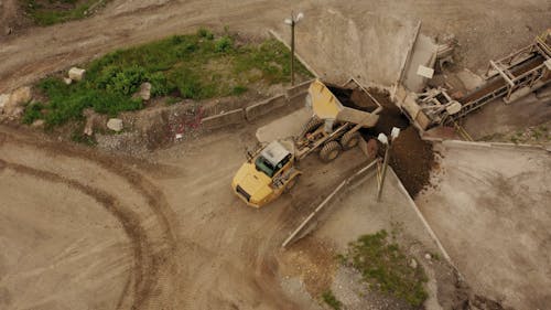 A Drone Shot of a Truck Pouring Soil