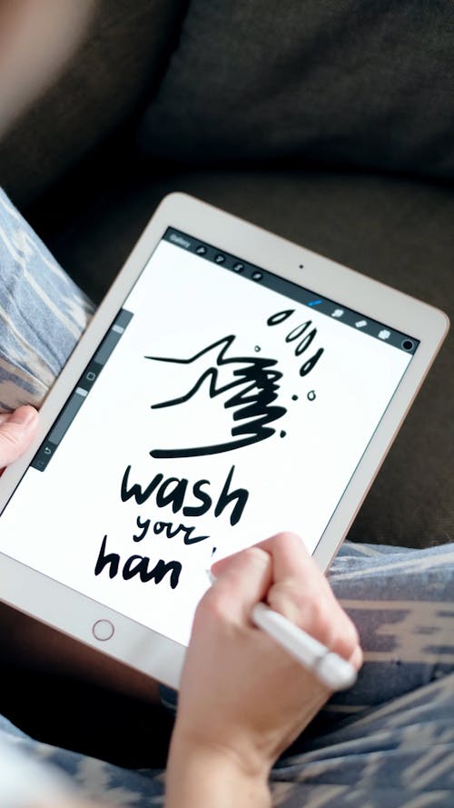 Person Drawing on a Tablet