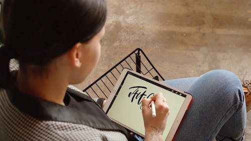 A Calligraphy Artist Writing on the Ipad