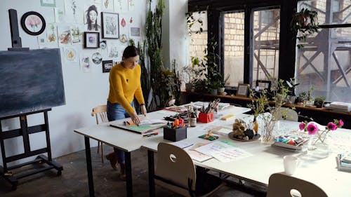 A Woman Flipping on Her Calligraphy Portfolio