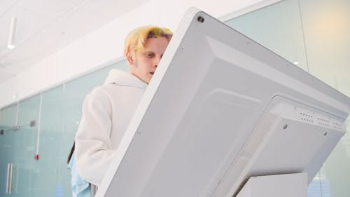 A Man Using a Touchscreen Computer