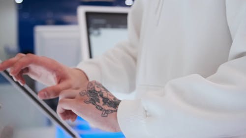 Man Typing on a Touchscreen Monitor