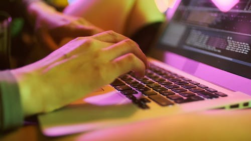 Close-Up Shot of a Person Typing on Laptop Keyboard