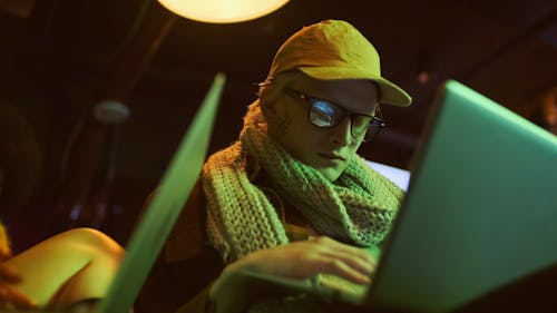 A Man Typing on his Laptop