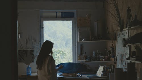 A Woman Painting on a Piece of Wood