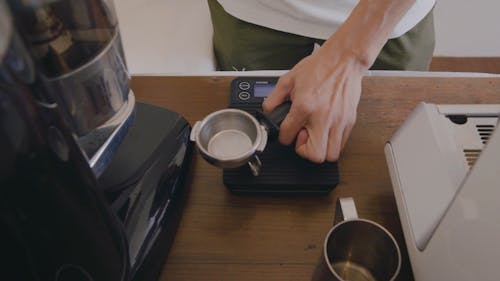 A Person Weighing a Ground Coffee