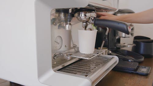 Close-Up Shot of a Person Doing Coffee