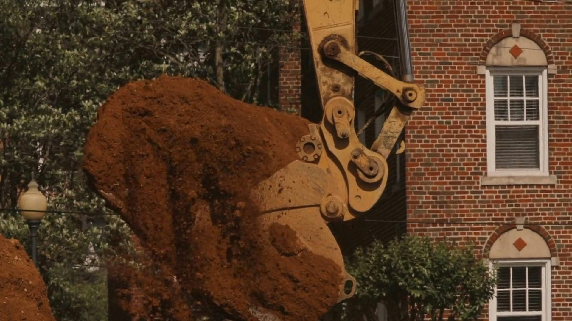 Using A Backhoe Digging Bucket In Transferring Ground Soil · Free Stock