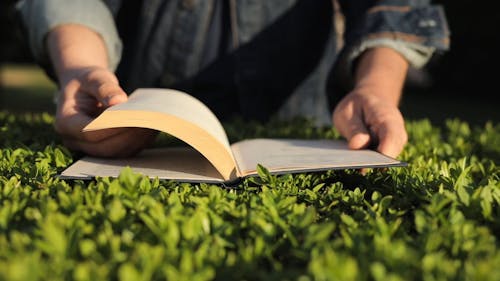 A Person Flipping The Pages Of A Book