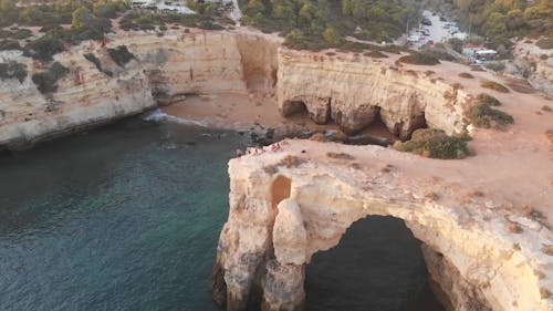 A Revolving Shot of People Standing on the Coastal Cliff