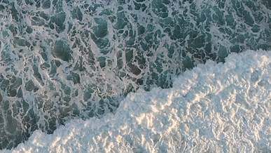 a drone shot over a rocky shore
