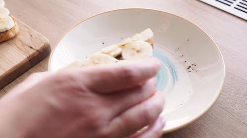 A Person Platting a Toasted Banana Topped Bread