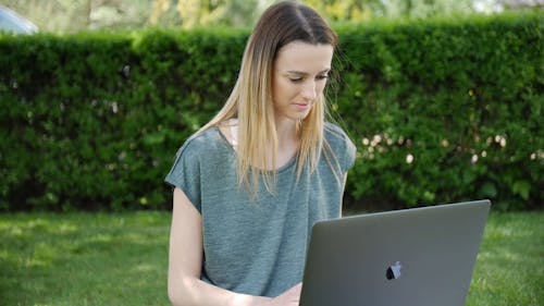 Woman Using Laptop Outdoor