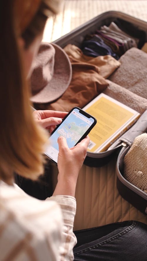 A Woman Checking  A Map Using Her Cellphone