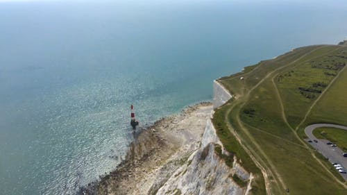 Red Lighthouse Near Cliff