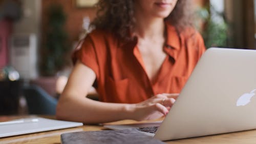 Woman Busy Typing on Her Laptop