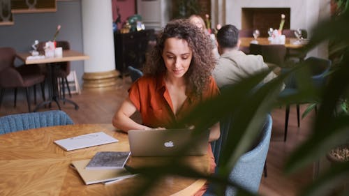 Woman Using Laptop In A Restaurant