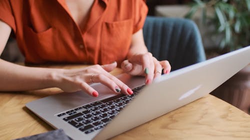 Woman Typing on Her Laptop