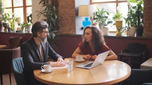 Business Meeting while Having Coffee