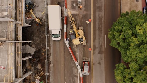 Vehicles Passing by the Construction Site