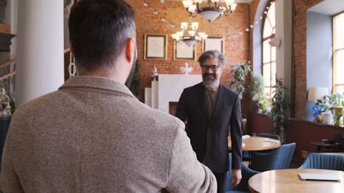 Two Men Having A Business Meeting In A Cafe
