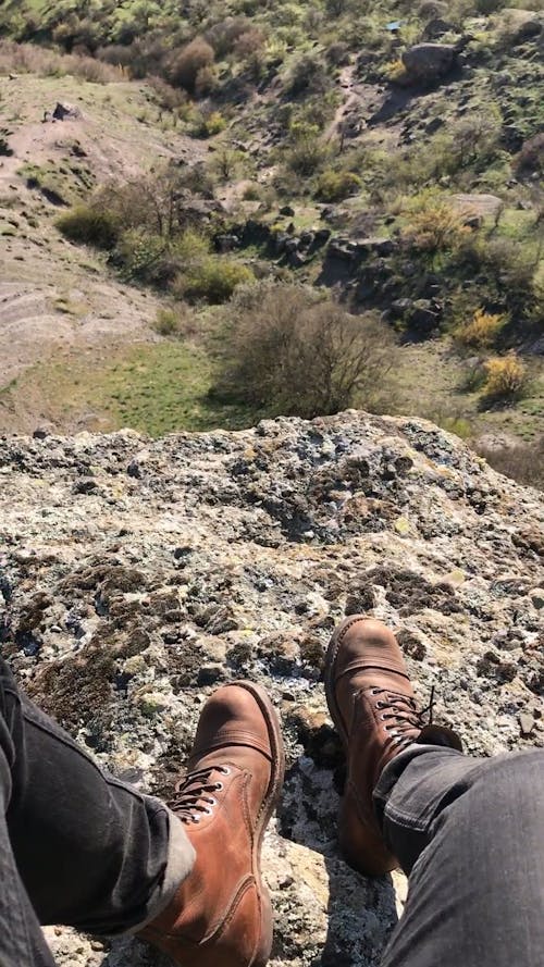 Person Sitting on a Cliff