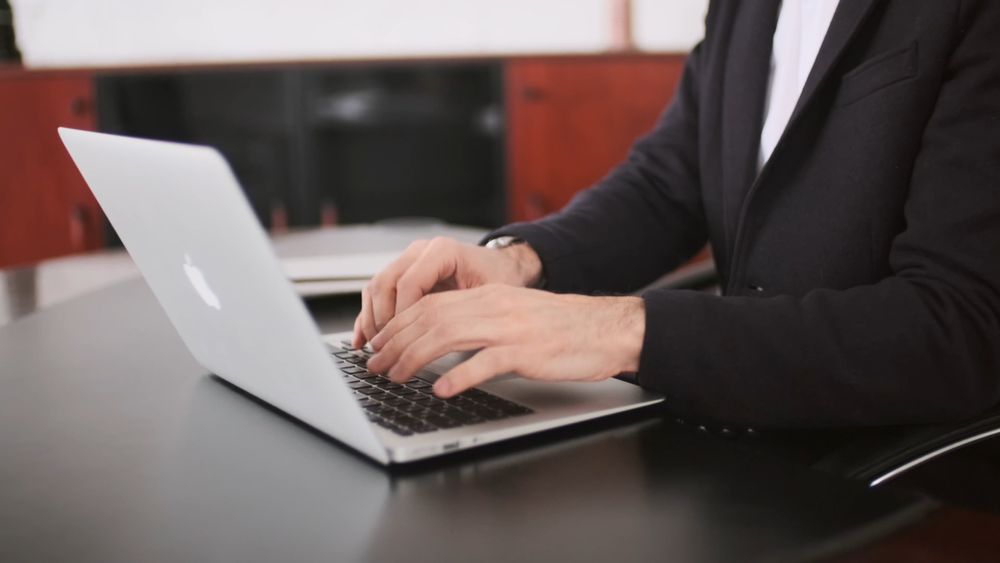 A Man Typing on His Laptop · Free Stock Video