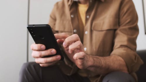 Man Texting on His Smartphone